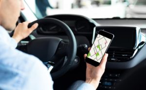 Man Driver Using Smartphone With Navigation Application Driving Car, Cropped