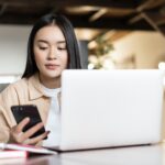 Remote work and distance education concept. Young asian business woman working with laptop, checking