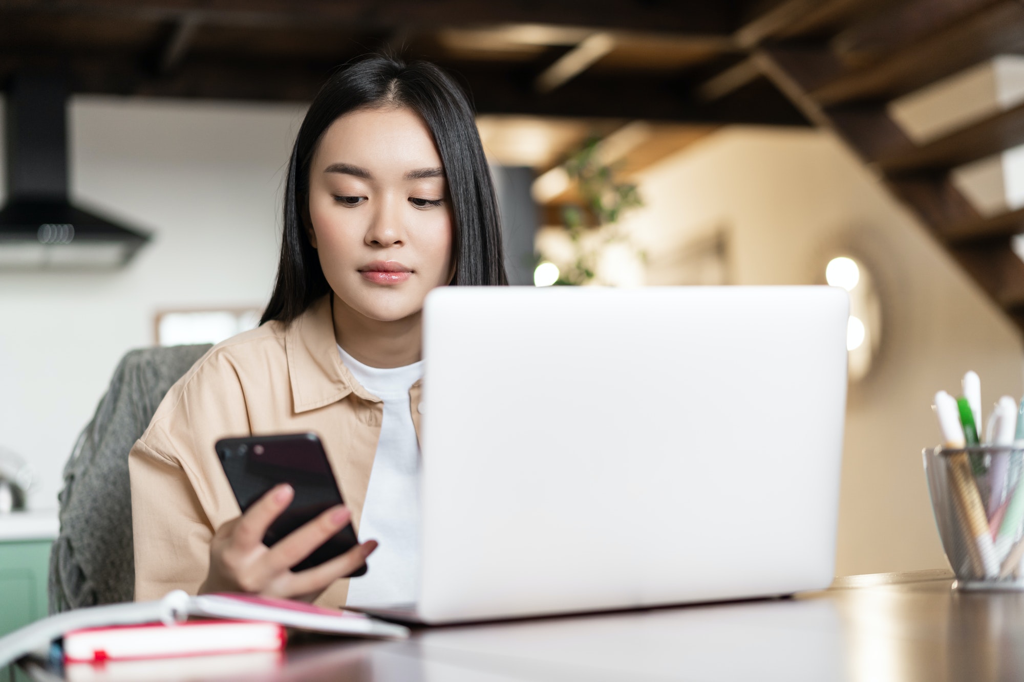 Remote work and distance education concept. Young asian business woman working with laptop, checking